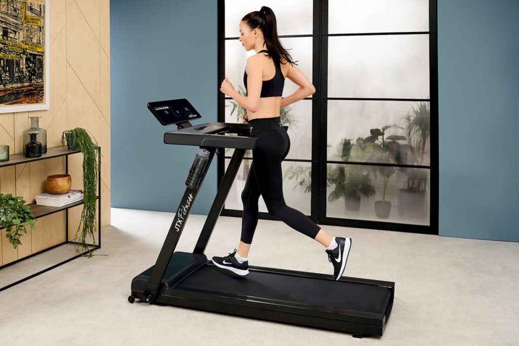 woman running on JTX Slimline treadmill